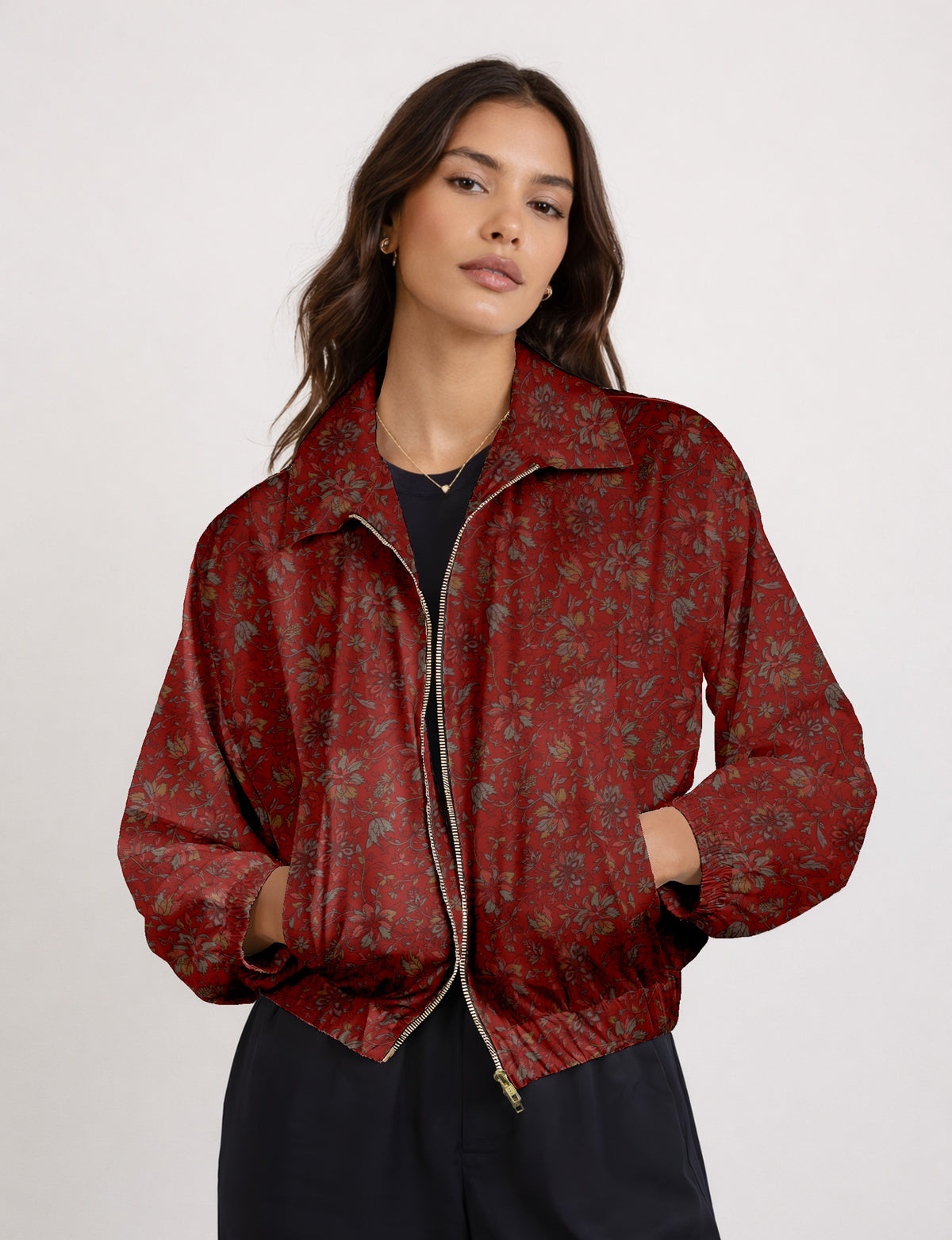 Brown floral bomber jacket with front zipper, elastic cuffs and hem, hanging on white hanger, red floral inner lining visible