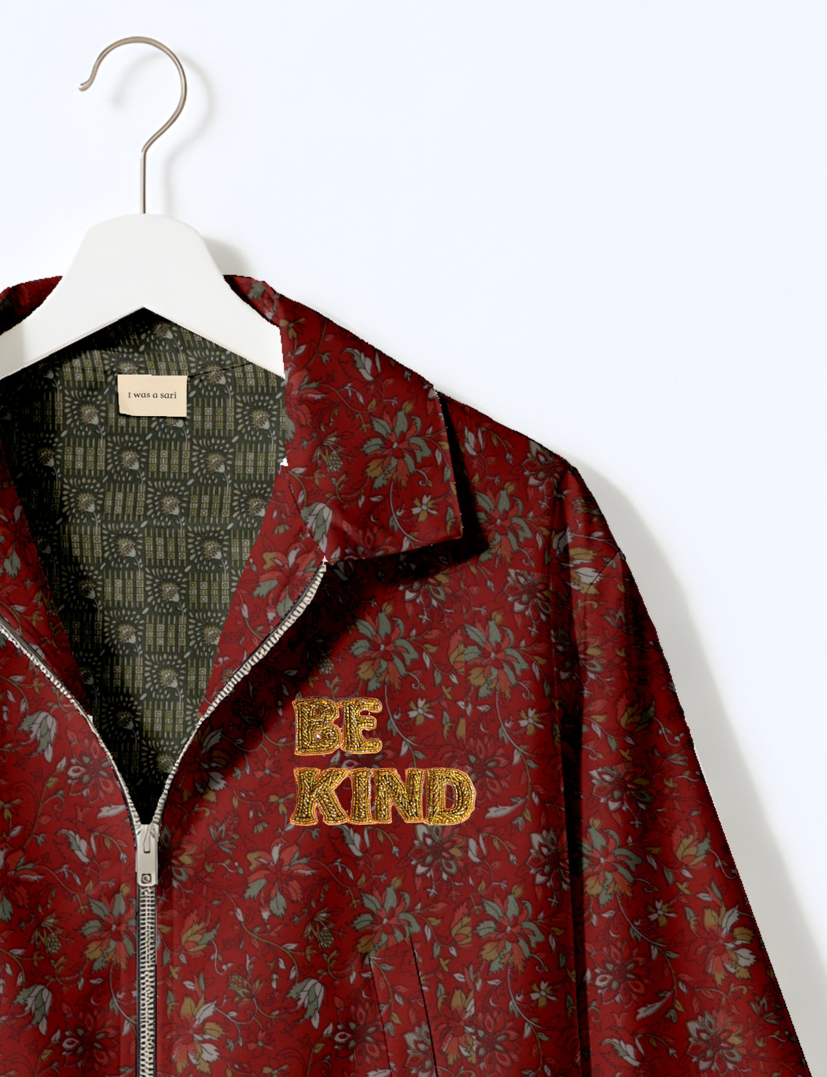 BE KIND Bomber jacket made from upcycled sari fabric with handcrafted Aari embroidery by female artisans.