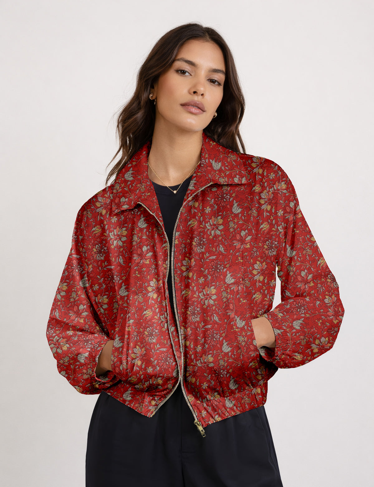 Brown floral bomber jacket with front zipper, elastic cuffs and hem, hanging on white hanger, red floral inner lining visible