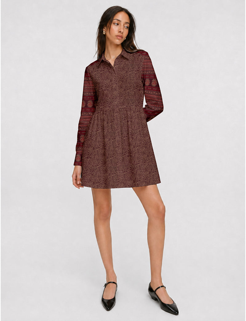 Short shirt dress with a relaxed A-line silhouette, point collar, partial button placket, gathered waist, side pockets, and full-length cuffed sleeves.