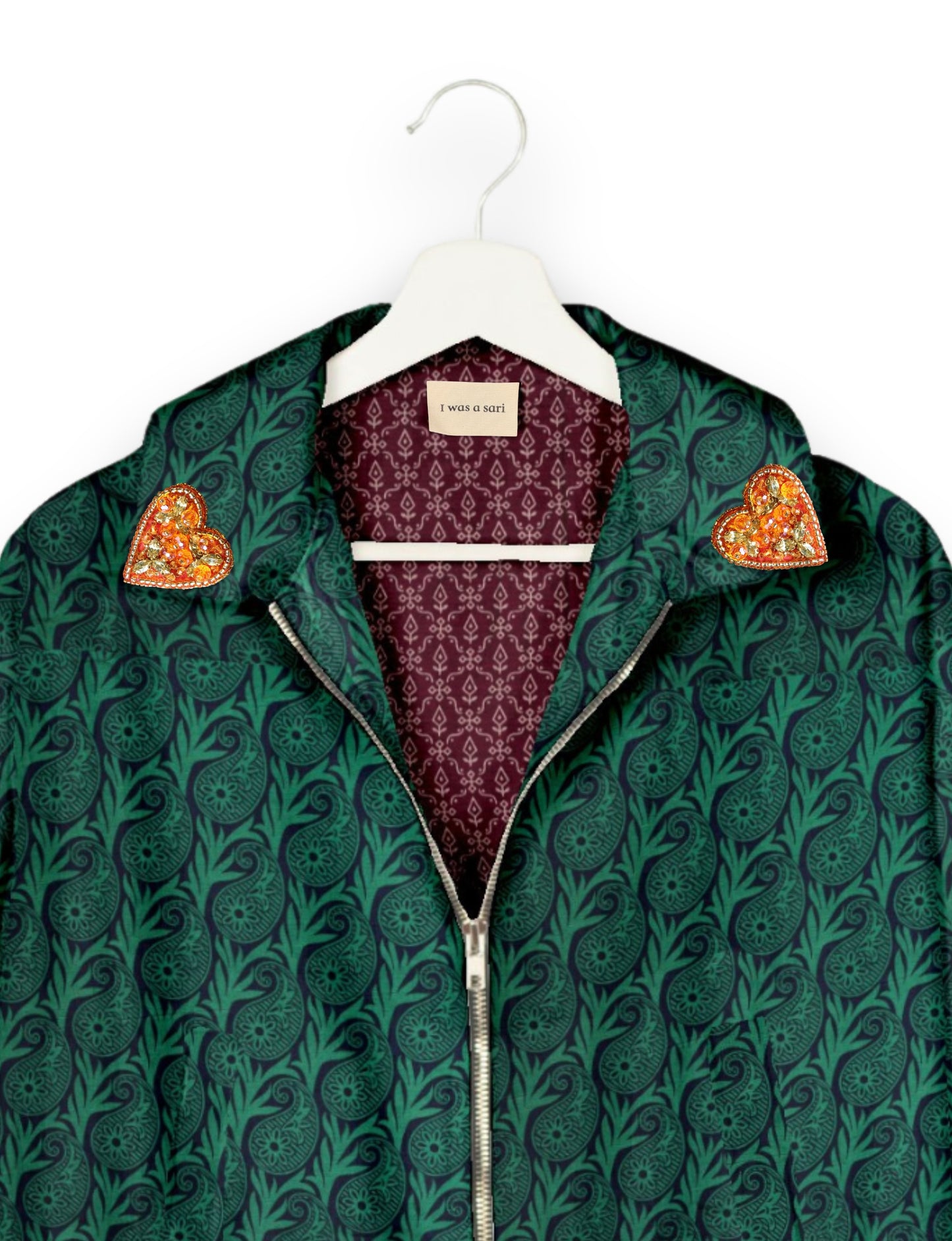 Make a bold statement with our Heart Drop Earrings, a symbol of conscious luxury and ethical fashion. Handcrafted using the intricate Aari embroidery technique, these earrings are made from upcycled sari fabric, embracing slow fashion and zero waste clothing. Elevate your look with sustainable apparel that supports fair trade fashion while reducing textile waste. Choose eco-friendly fashion that speaks of love, artistry, and responsibility.