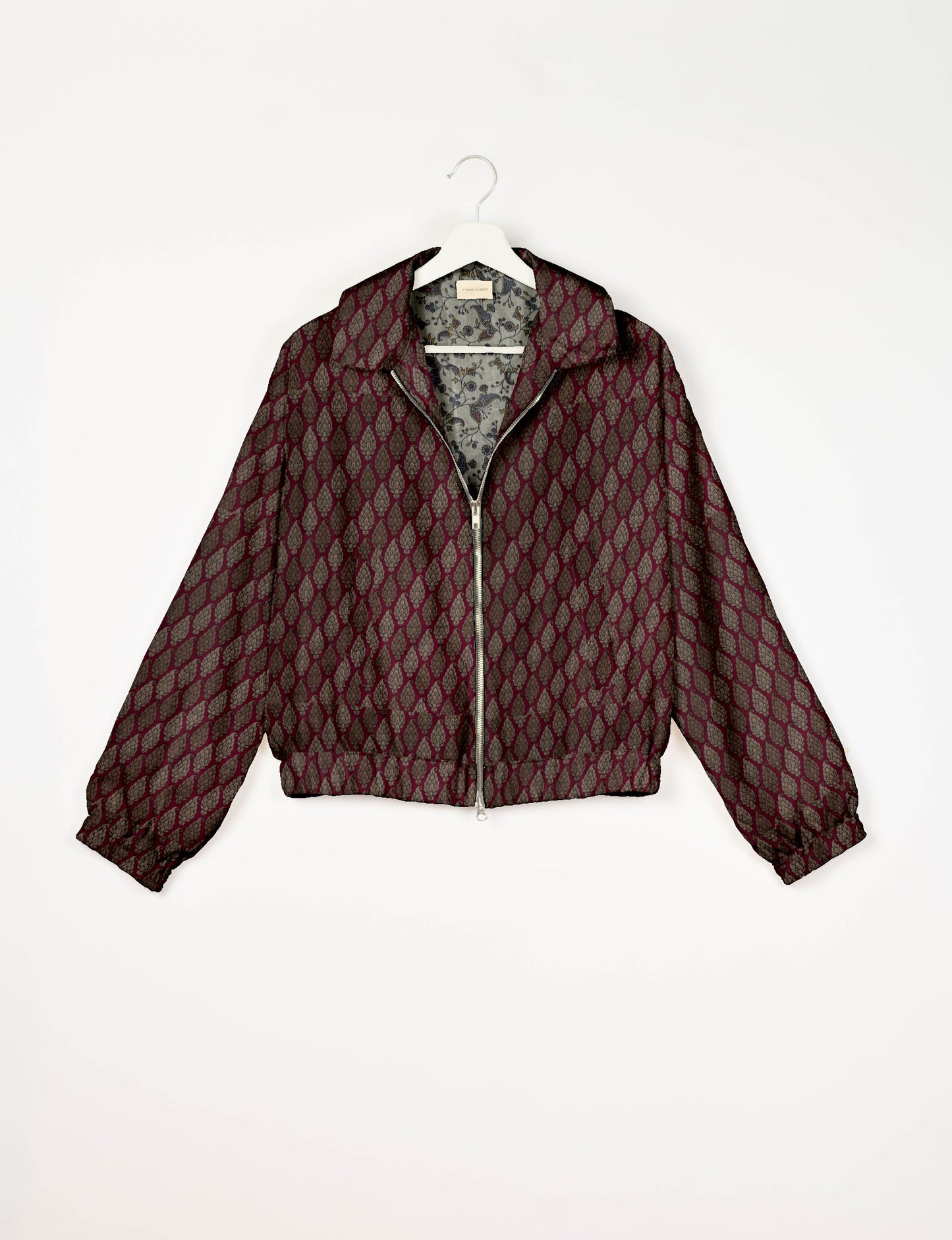 Upcycled Bomber Jacket made from recycled sari materials, featuring a cute cropped shape, elasticated hem and cuffs, and contrast sari print lining. Sustainable apparel promoting eco-friendly fashion and ethical clothing.