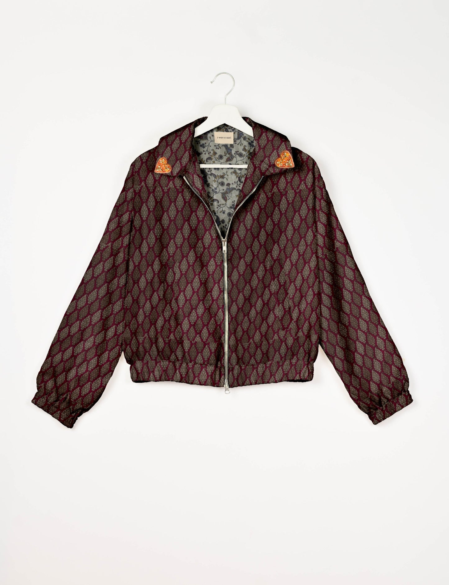 Make a bold statement with our Heart Drop Earrings, a symbol of conscious luxury and ethical fashion. Handcrafted using the intricate Aari embroidery technique, these earrings are made from upcycled sari fabric, embracing slow fashion and zero waste clothing. Elevate your look with sustainable apparel that supports fair trade fashion while reducing textile waste. Choose eco-friendly fashion that speaks of love, artistry, and responsibility.