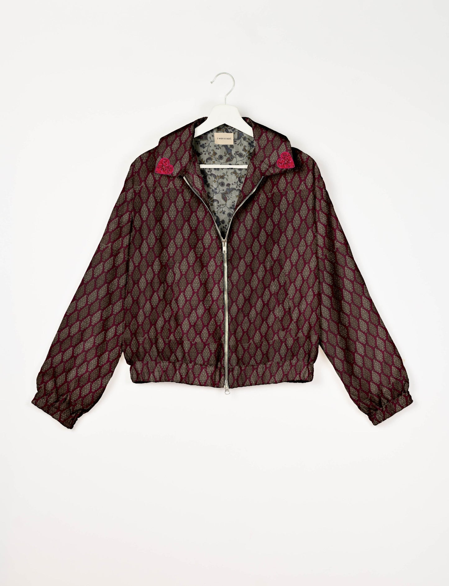 Make a bold statement with our Heart Drop Earrings, a symbol of conscious luxury and ethical fashion. Handcrafted using the intricate Aari embroidery technique, these earrings are made from upcycled sari fabric, embracing slow fashion and zero waste clothing. Elevate your look with sustainable apparel that supports fair trade fashion while reducing textile waste. Choose eco-friendly fashion that speaks of love, artistry, and responsibility.