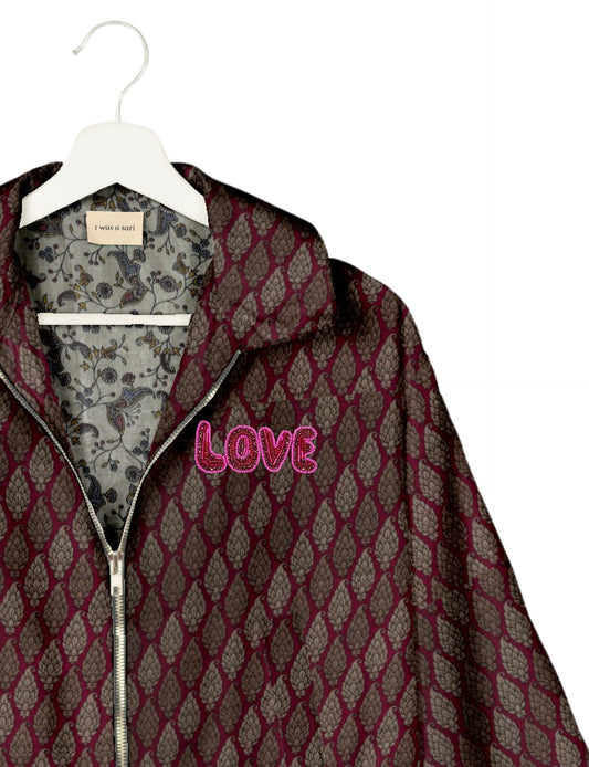 Love Bomber Jacket made from recycled fabric, featuring hand-stitched Aari embroidery. A unique piece of zero-waste clothing, part of the circular fashion movement. Designed with upcycled materials for a stylish yet environmentally friendly clothing choice.