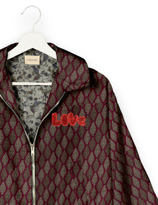 Love Bomber Jacket made from recycled fabric, featuring hand-stitched Aari embroidery. A unique piece of zero-waste clothing, part of the circular fashion movement. Designed with upcycled materials for a stylish yet environmentally friendly clothing choice.