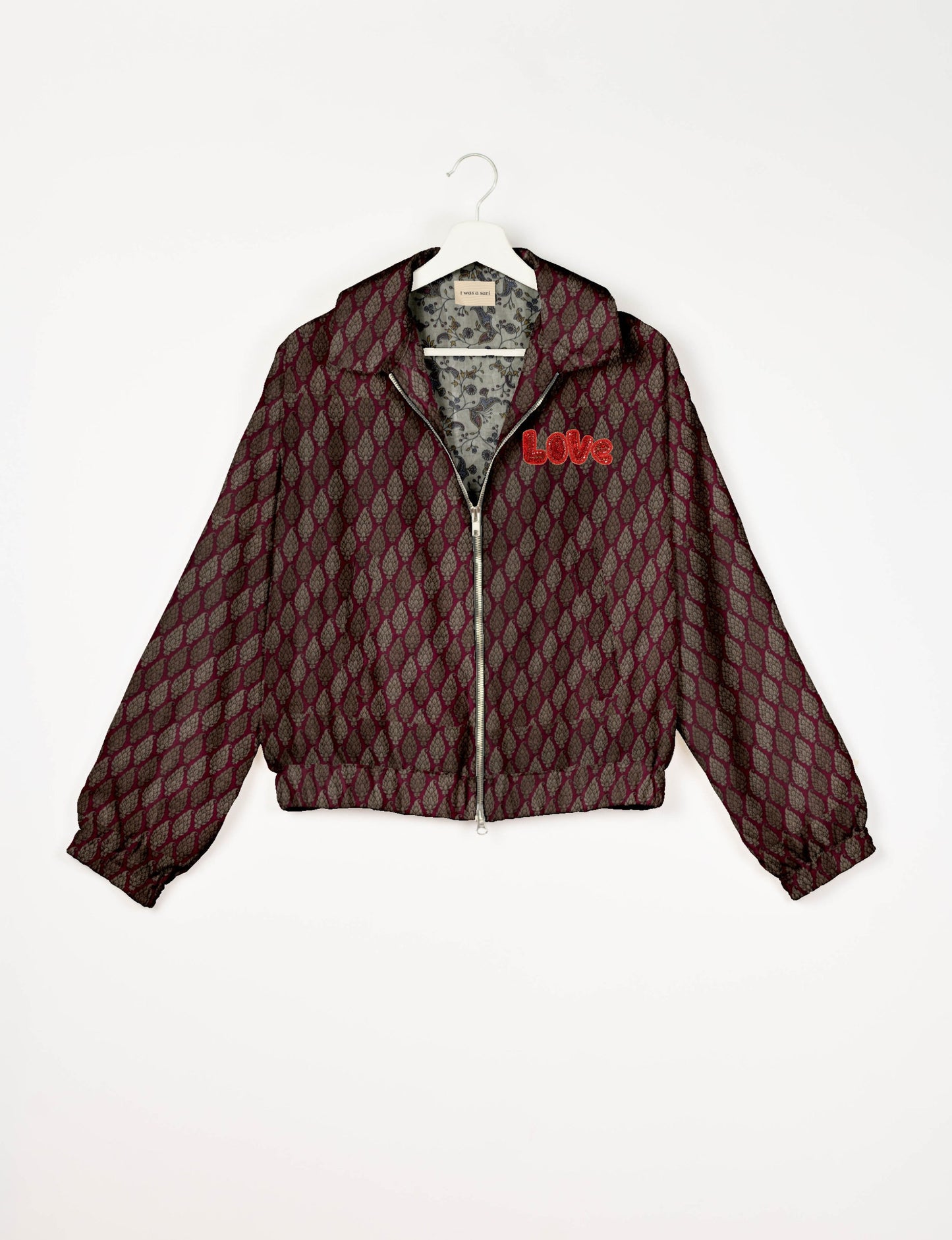 Love Bomber Jacket made from recycled fabric, featuring hand-stitched Aari embroidery. A unique piece of zero-waste clothing, part of the circular fashion movement. Designed with upcycled materials for a stylish yet environmentally friendly clothing choice.