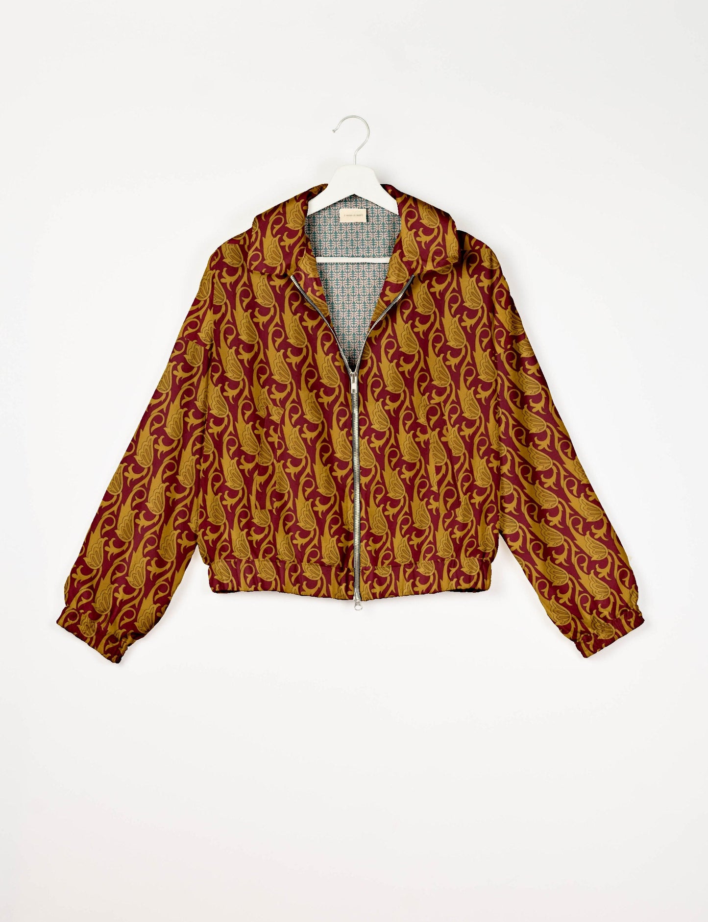 Stylish BOMBER JACKET, an upcycled clothing masterpiece with a cute cropped shape, elasticated details, and detachable metallic zipper. Contrast sari print lining adds a unique touch. Explore sustainable and eco-friendly fashion.