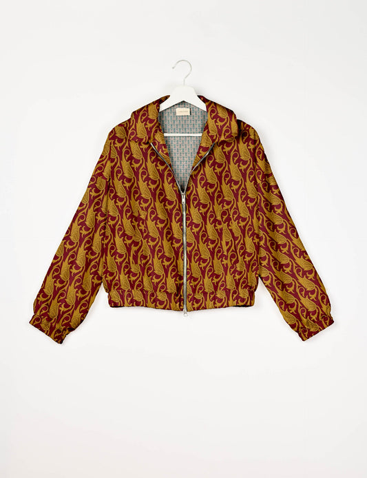 Stylish BOMBER JACKET, an upcycled clothing masterpiece with a cute cropped shape, elasticated details, and detachable metallic zipper. Contrast sari print lining adds a unique touch. Explore sustainable and eco-friendly fashion.