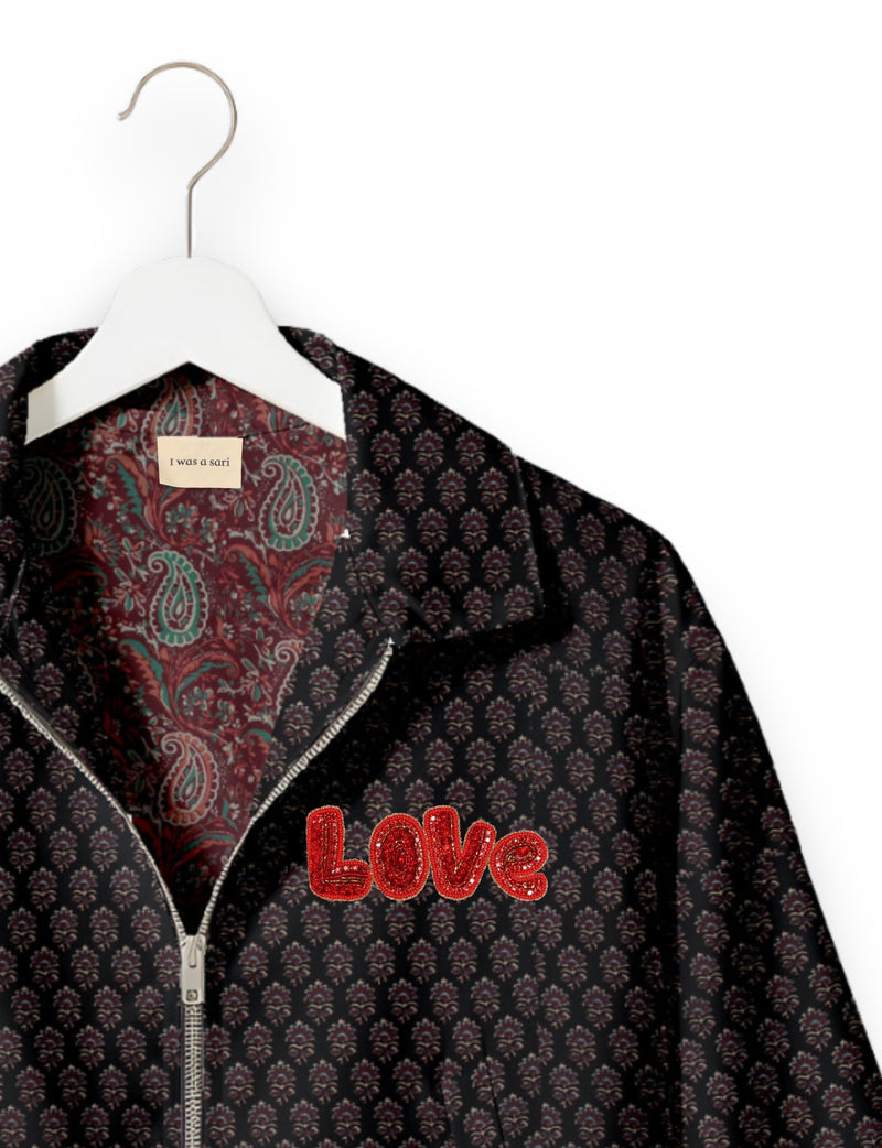 Love Bomber Jacket made from recycled fabric, featuring hand-stitched Aari embroidery. A unique piece of zero-waste clothing, part of the circular fashion movement. Designed with upcycled materials for a stylish yet environmentally friendly clothing choice.