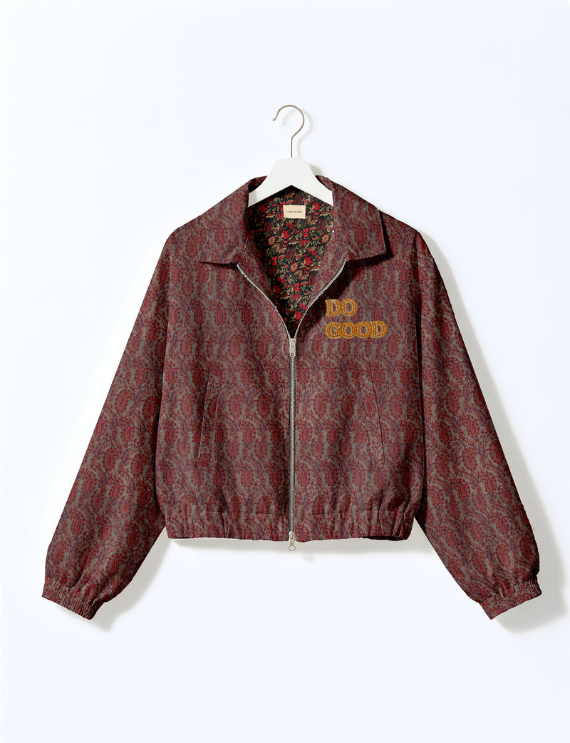 Gold cropped DO GOOD bomber jacket featuring hand-embroidered lettering on the left chest, contrasting inner lining and two functional pockets.
