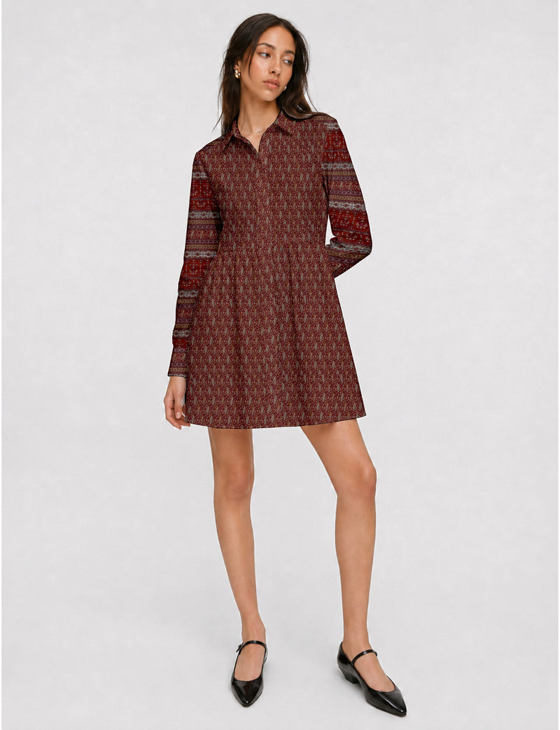Short shirt dress with a relaxed A-line silhouette, point collar, partial button placket, gathered waist, side pockets, and full-length cuffed sleeves.