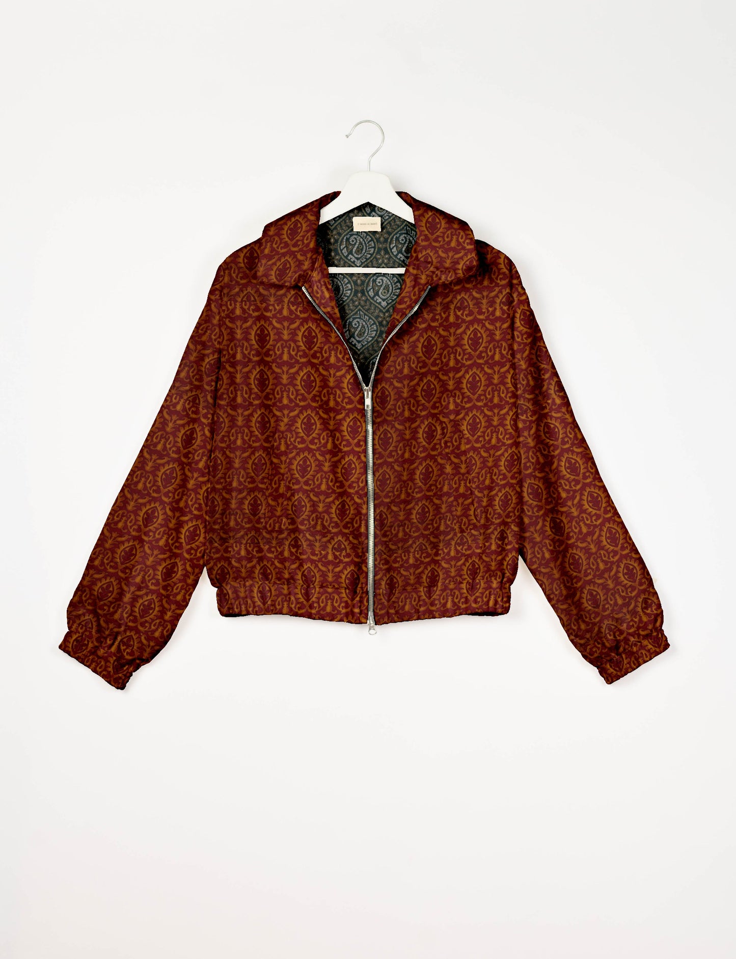 Upcycled Bomber Jacket made from recycled sari materials, featuring a cute cropped shape, elasticated hem and cuffs, and contrast sari print lining. Sustainable apparel promoting eco-friendly fashion and ethical clothing.