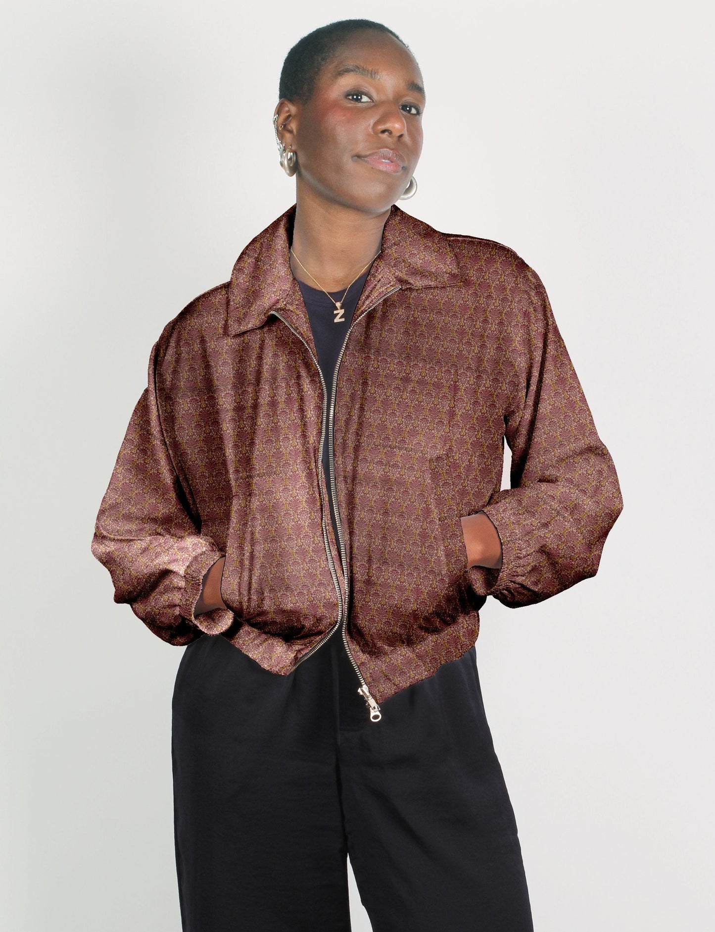 Upcycled Bomber Jacket made from recycled sari materials, featuring a cute cropped shape, elasticated hem and cuffs, and contrast sari print lining. Sustainable apparel promoting eco-friendly fashion and ethical clothing.