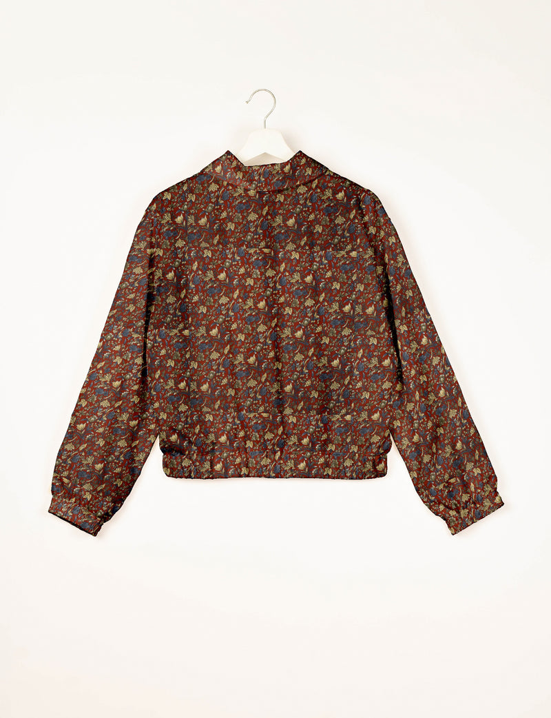 Floral patterned bomber jacket in red, blue, and beige colors, shown from back on white hanger