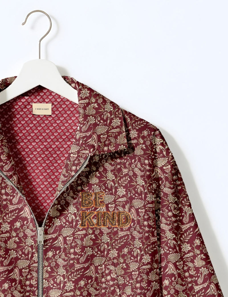 BE KIND Bomber jacket made from upcycled sari fabric with handcrafted Aari embroidery by female artisans.