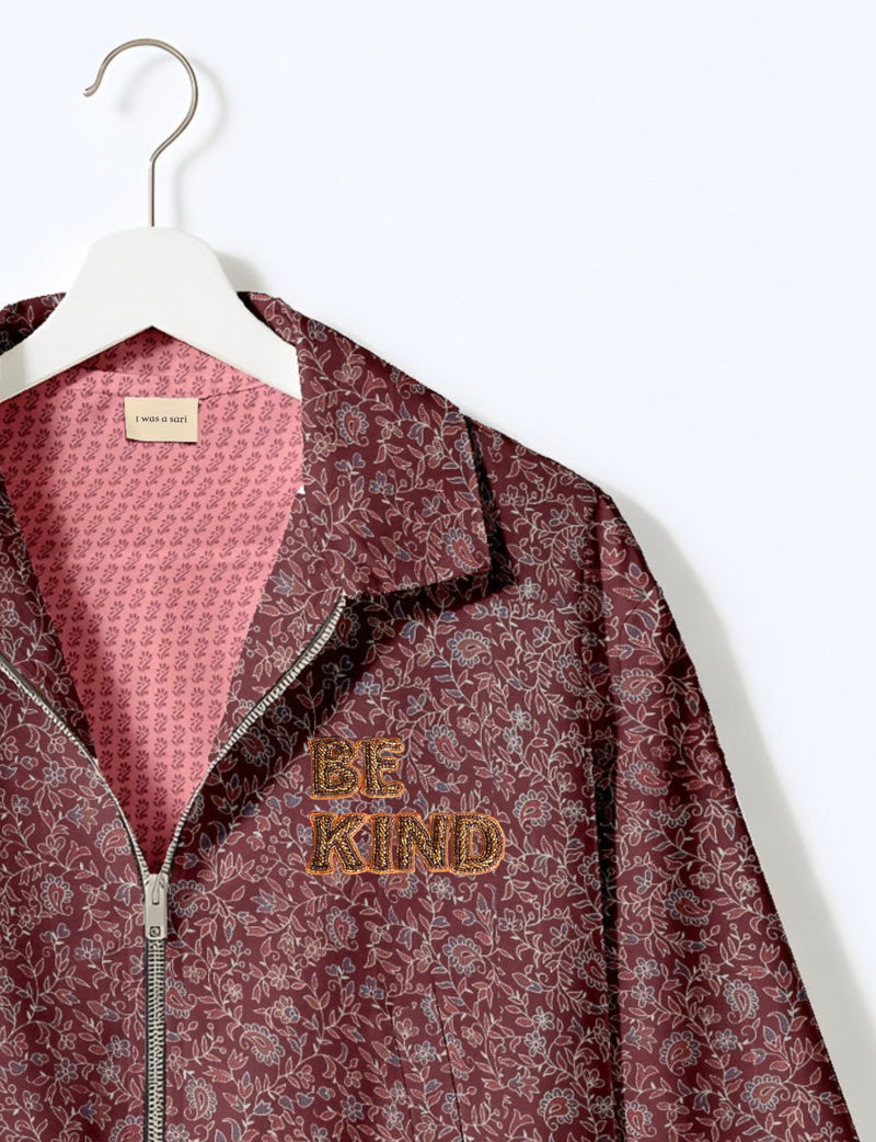 BE KIND Bomber jacket made from upcycled sari fabric with handcrafted Aari embroidery by female artisans.
