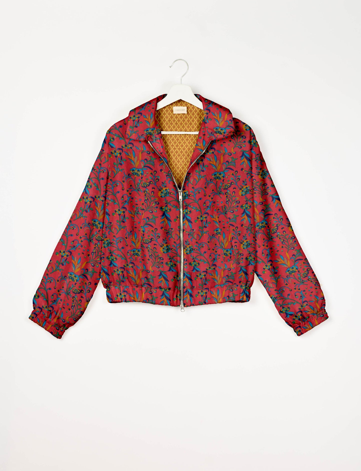 Upcycled Bomber Jacket made from recycled sari materials, featuring a cute cropped shape, elasticated hem and cuffs, and contrast sari print lining. Sustainable apparel promoting eco-friendly fashion and ethical clothing.