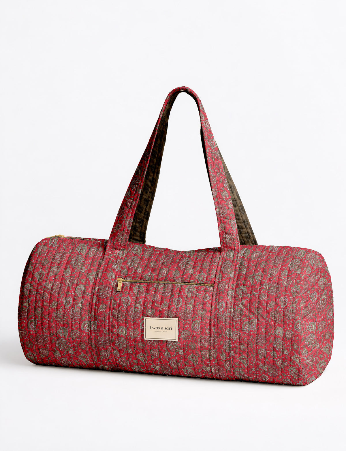 Brown paisley quilted bowling bag with dual handles, front zipper pocket, and "I was a sari" label on front side