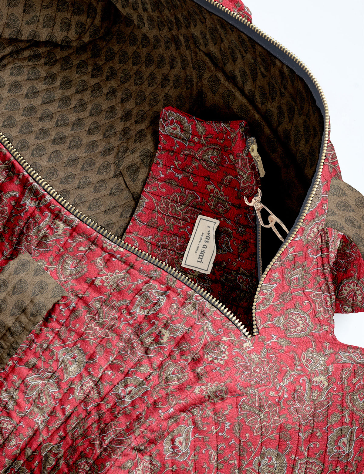 Brown paisley quilted bowling bag with dual handles, front zipper pocket, and "I was a sari" label on front side