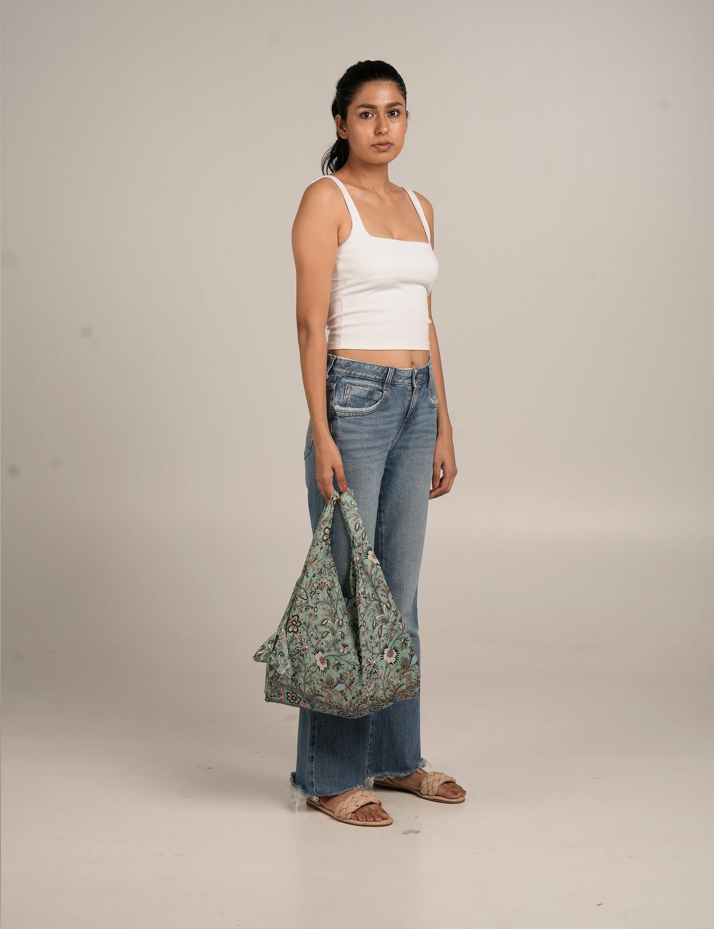 Stay eco-conscious with our Reusable Bag, handmade by Indian artisans from pre-loved saris. Silky and lightweight, this foldaway bag is perfect for your on-the-go lifestyle. Each piece is a unique statement of ethical fashion, embracing sustainability and style.