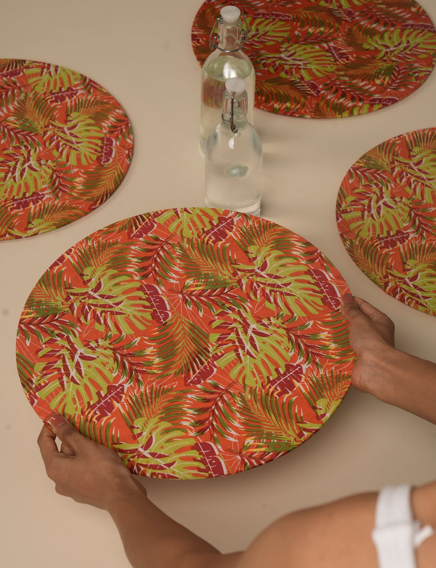 Upgrade your table settings with our Round Placemat Set of 4. These circular placemats, made from sustainable 3 mm thick MDF, feature covers crafted from round sari sleeves. Easily washable and elasticated, these placemats offer a stylish and eco-friendly solution for both table place settings and serving dishes. Make a sustainable statement with every meal.