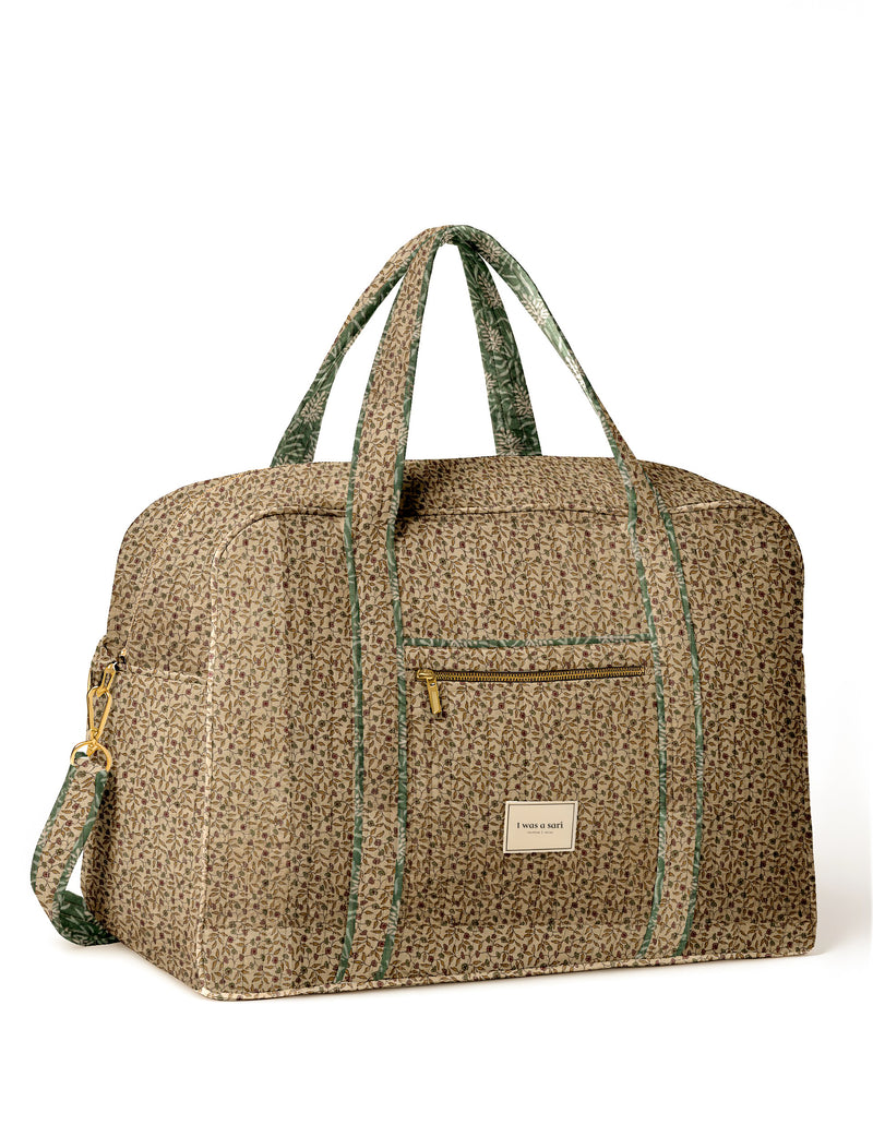 Beige and green floral patterned duffle travel bag with front zipper pocket and dual handles, shown front view on white background