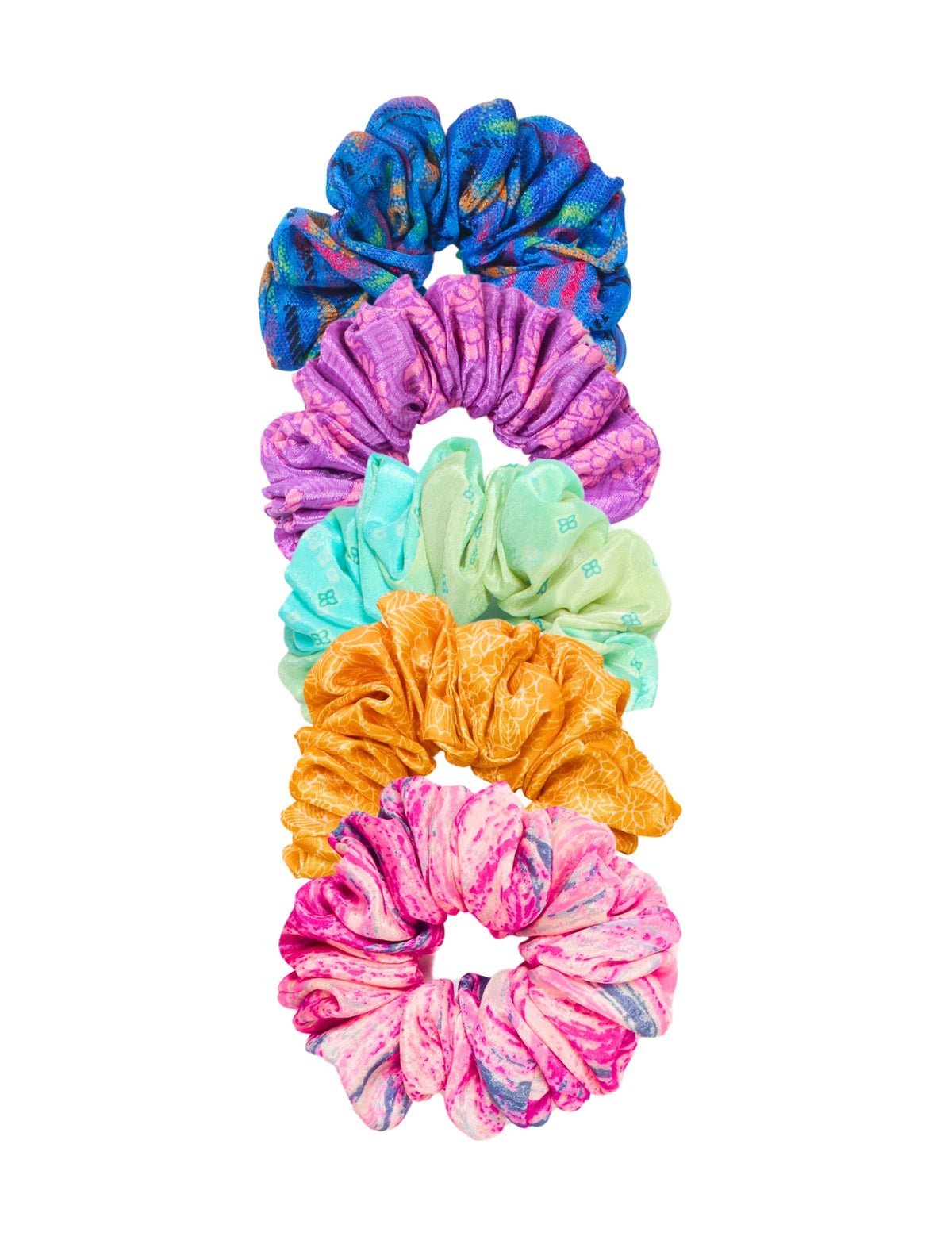 Set of five colorful fabric scrunchies in blue, purple, mint green, orange, and pink with various patterns, flat lay