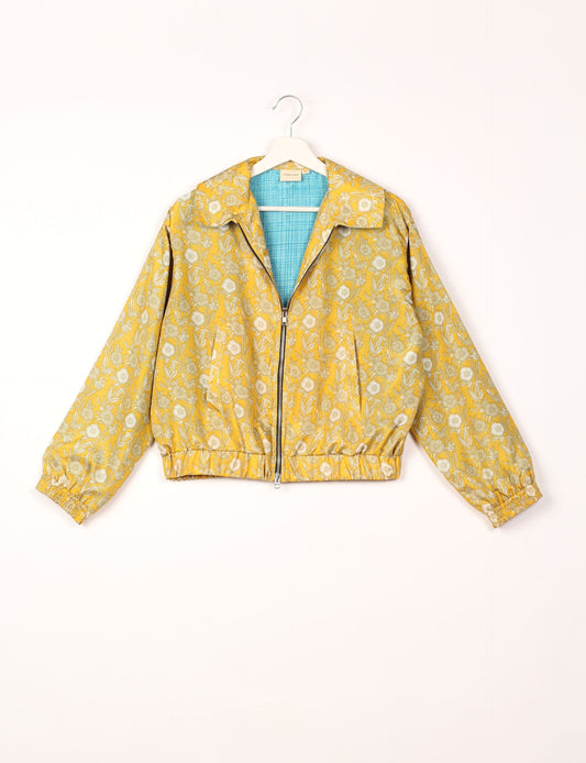 Stylish BOMBER JACKET, an upcycled clothing masterpiece with a cute cropped shape, elasticated details, and detachable metallic zipper. Contrast sari print lining adds a unique touch. Explore sustainable and eco-friendly fashion.