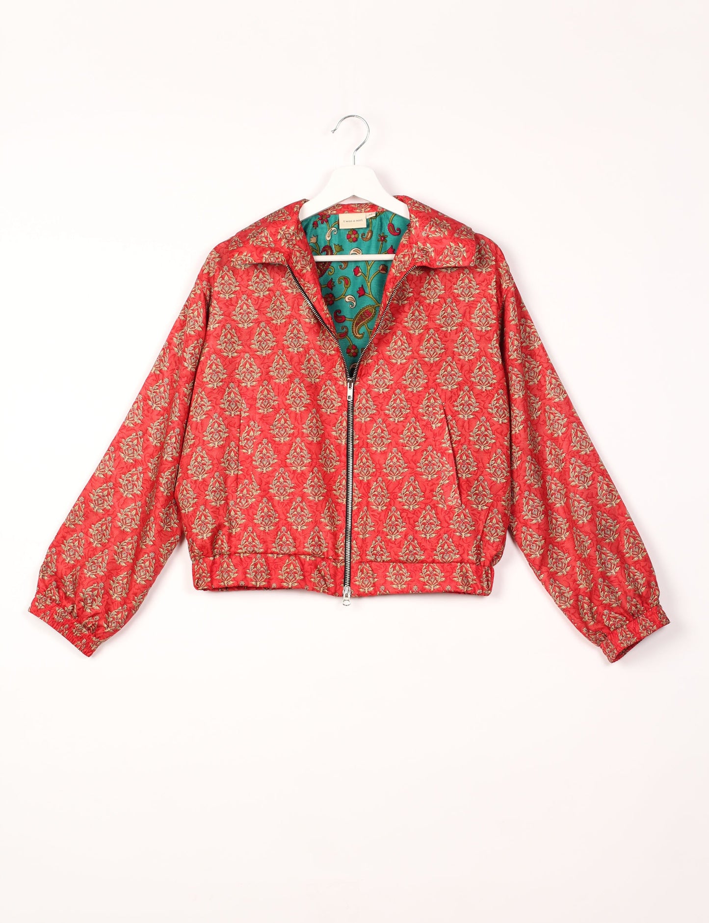 Stylish BOMBER JACKET, an upcycled clothing masterpiece with a cute cropped shape, elasticated details, and detachable metallic zipper. Contrast sari print lining adds a unique touch. Explore sustainable and eco-friendly fashion.