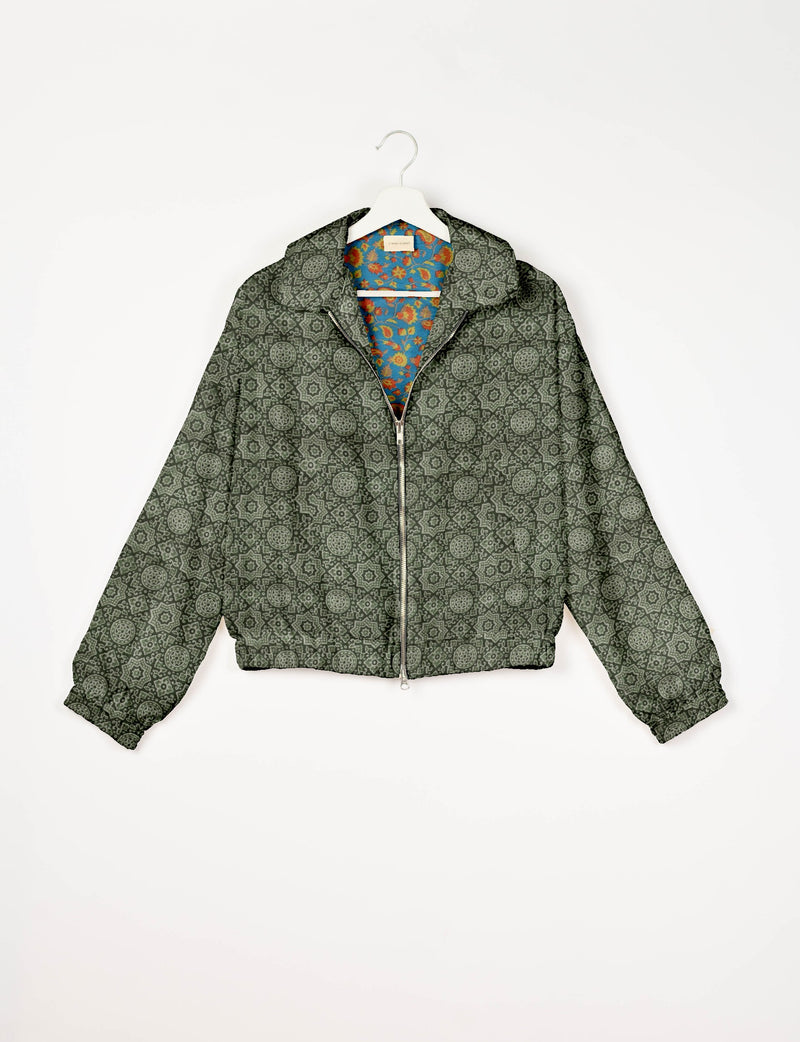 Green bomber jacket with Indian ethnic pattern, front zipper, elastic cuffs, and floral inner lining, shown on hanger