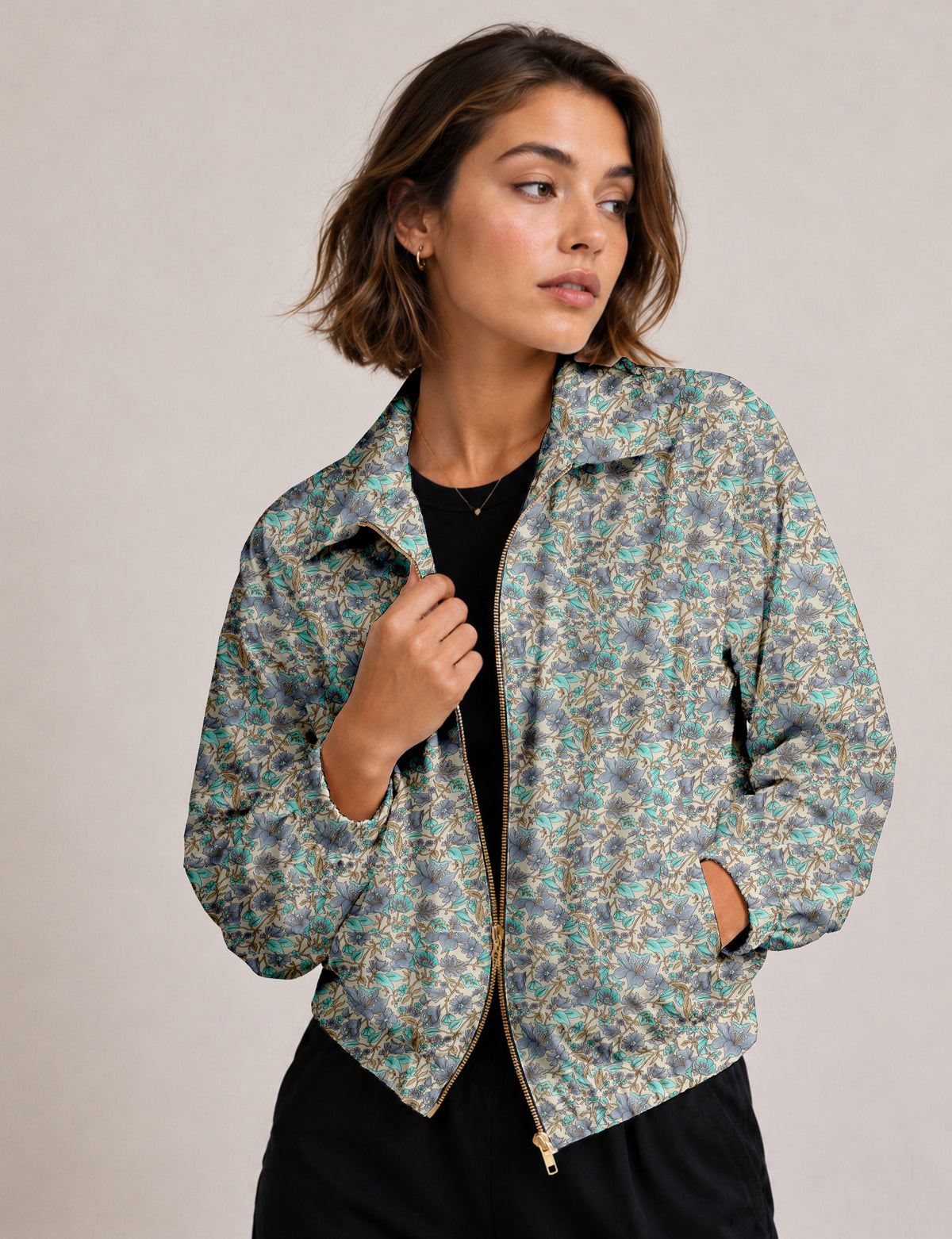 Brown floral bomber jacket with front zipper, elastic cuffs and hem, hanging on white hanger, red floral inner lining visible