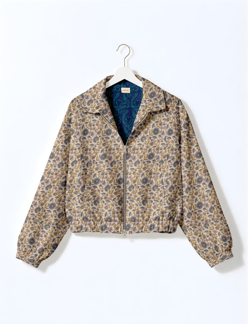 Woman wearing a yellow floral bomber jacket with front zipper, elastic cuffs, and side pockets, shown from front view