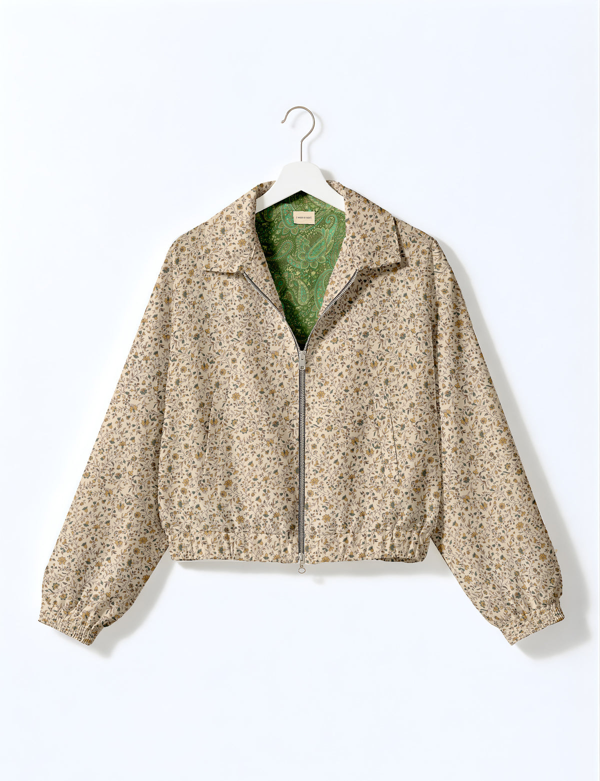 Woman wearing a yellow floral bomber jacket with front zipper, elastic cuffs, and side pockets, shown from front view