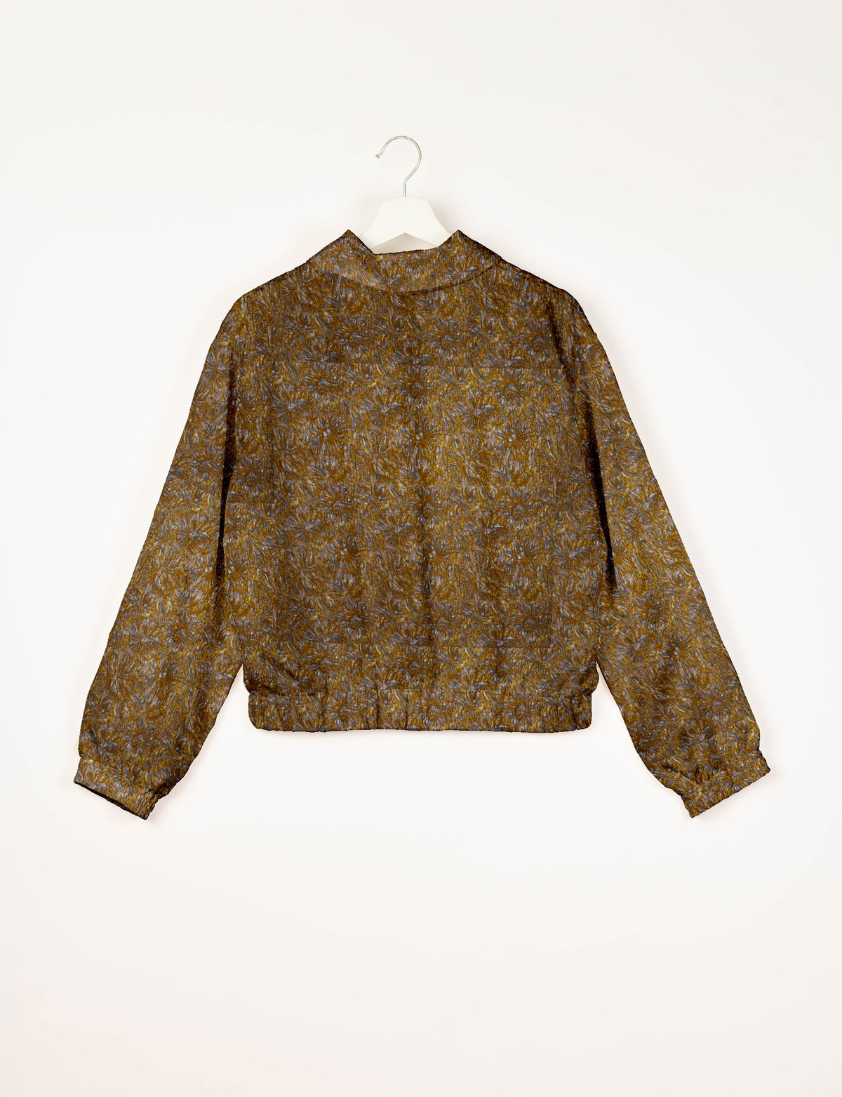 Yellow and gray abstract patterned bomber jacket with elastic cuffs and waistband, shown from back on white hanger