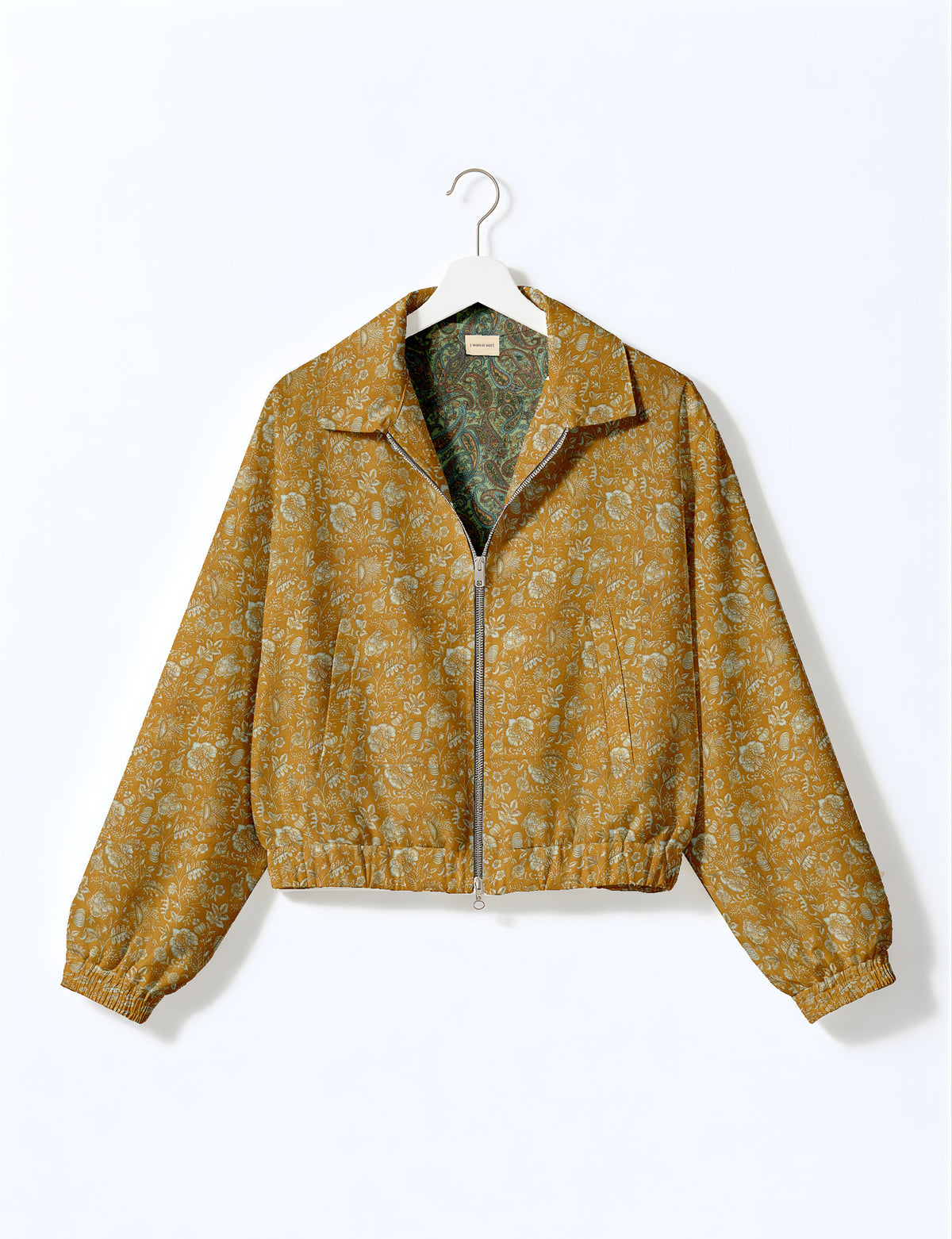 Woman wearing a yellow floral bomber jacket with front zipper, elastic cuffs, and side pockets, shown from front view