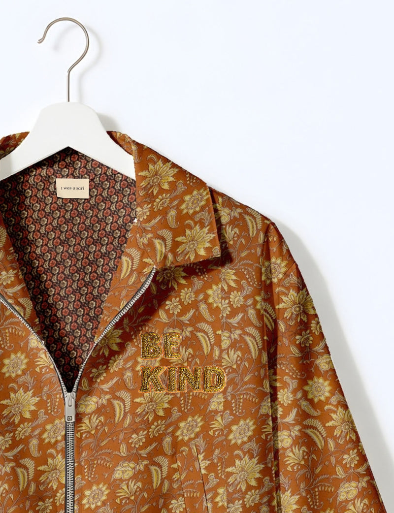 BE KIND Bomber jacket made from upcycled sari fabric with handcrafted Aari embroidery by female artisans.