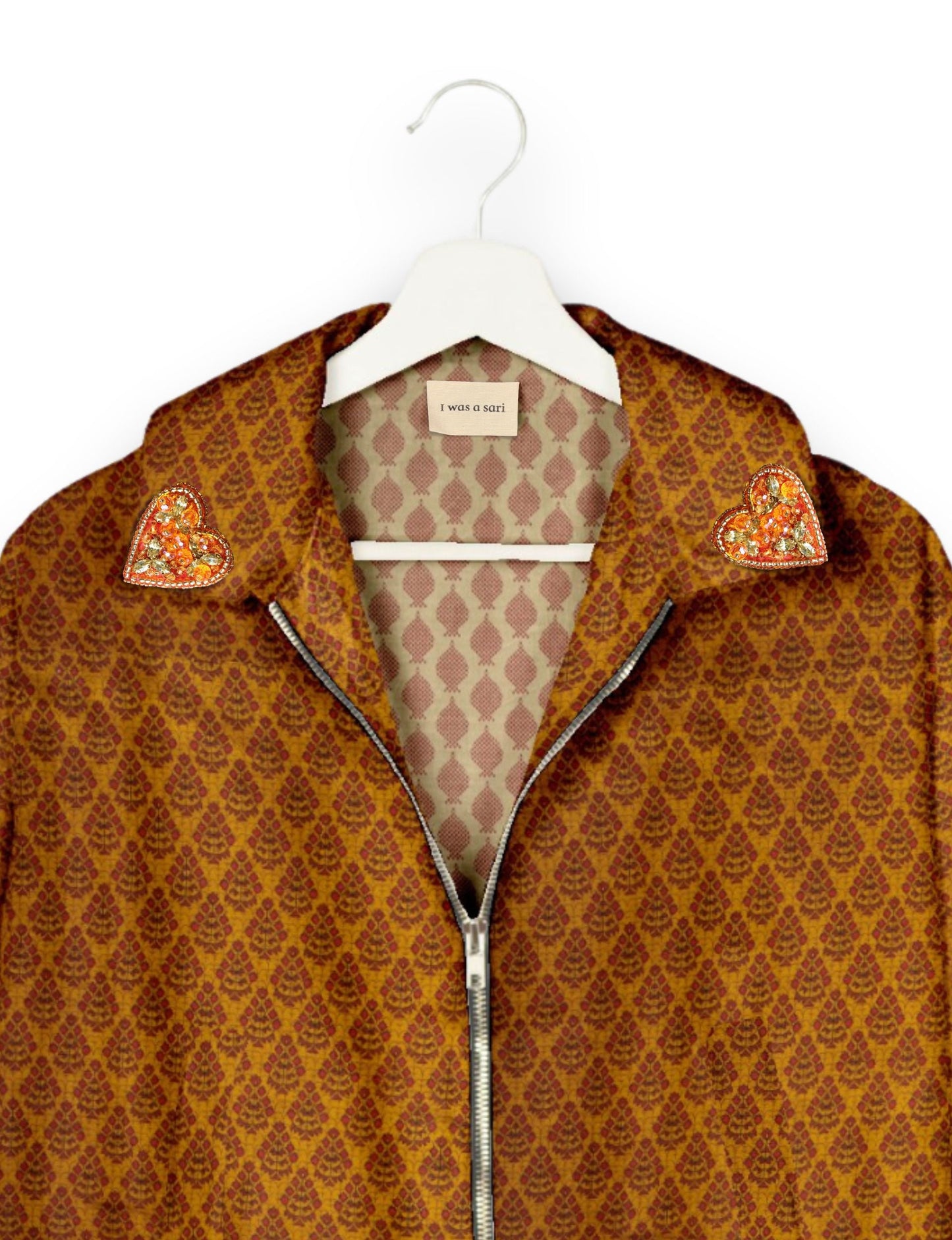 Make a bold statement with our Heart Drop Earrings, a symbol of conscious luxury and ethical fashion. Handcrafted using the intricate Aari embroidery technique, these earrings are made from upcycled sari fabric, embracing slow fashion and zero waste clothing. Elevate your look with sustainable apparel that supports fair trade fashion while reducing textile waste. Choose eco-friendly fashion that speaks of love, artistry, and responsibility.