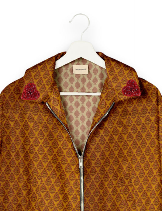 Make a bold statement with our Heart Drop Earrings, a symbol of conscious luxury and ethical fashion. Handcrafted using the intricate Aari embroidery technique, these earrings are made from upcycled sari fabric, embracing slow fashion and zero waste clothing. Elevate your look with sustainable apparel that supports fair trade fashion while reducing textile waste. Choose eco-friendly fashion that speaks of love, artistry, and responsibility.