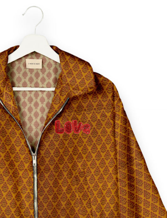Love Bomber Jacket made from recycled fabric, featuring hand-stitched Aari embroidery. A unique piece of zero-waste clothing, part of the circular fashion movement. Designed with upcycled materials for a stylish yet environmentally friendly clothing choice.