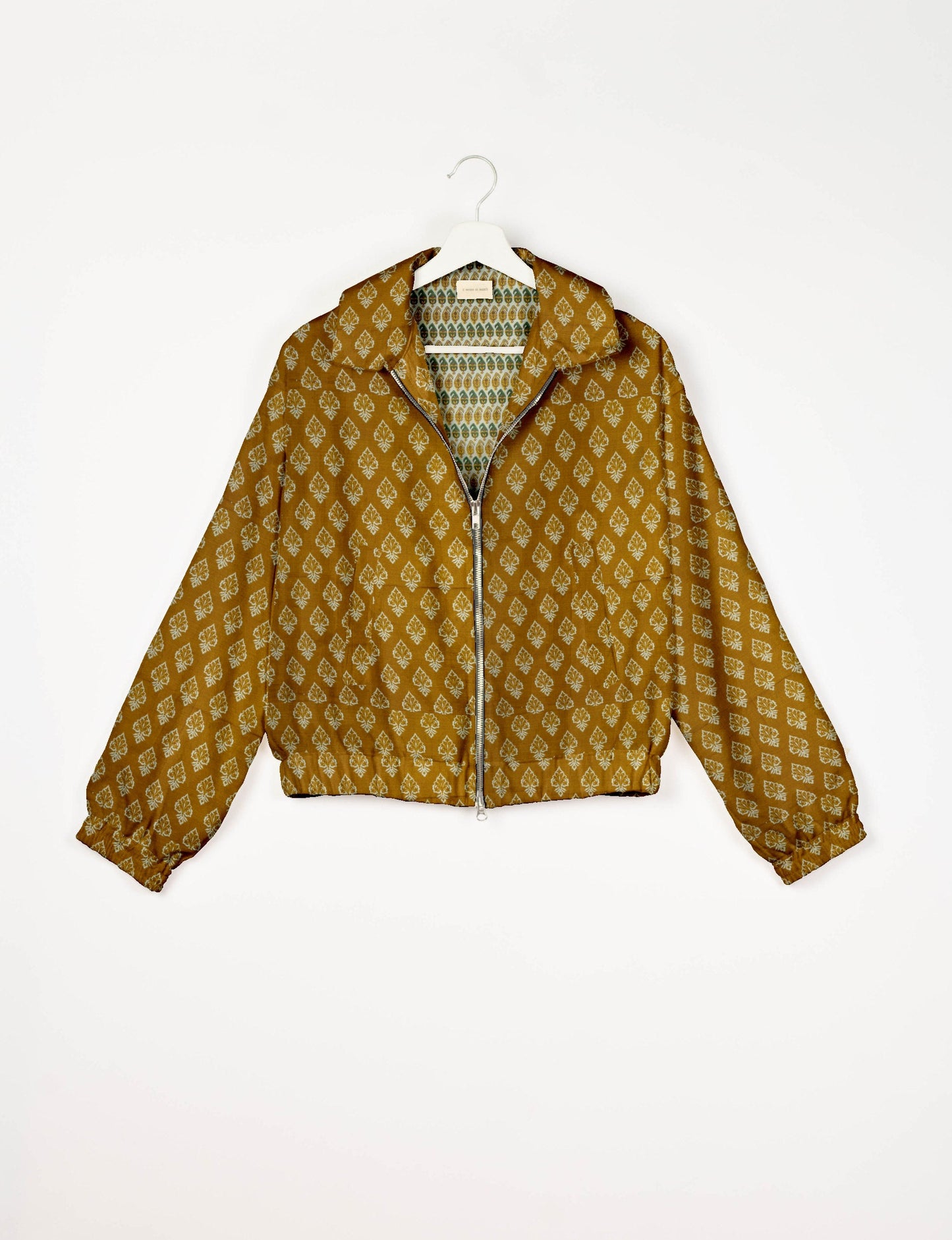 Upcycled Bomber Jacket made from recycled sari materials, featuring a cute cropped shape, elasticated hem and cuffs, and contrast sari print lining. Sustainable apparel promoting eco-friendly fashion and ethical clothing.