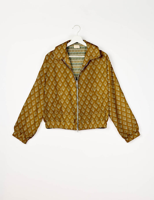 Upcycled Bomber Jacket made from recycled sari materials, featuring a cute cropped shape, elasticated hem and cuffs, and contrast sari print lining. Sustainable apparel promoting eco-friendly fashion and ethical clothing.