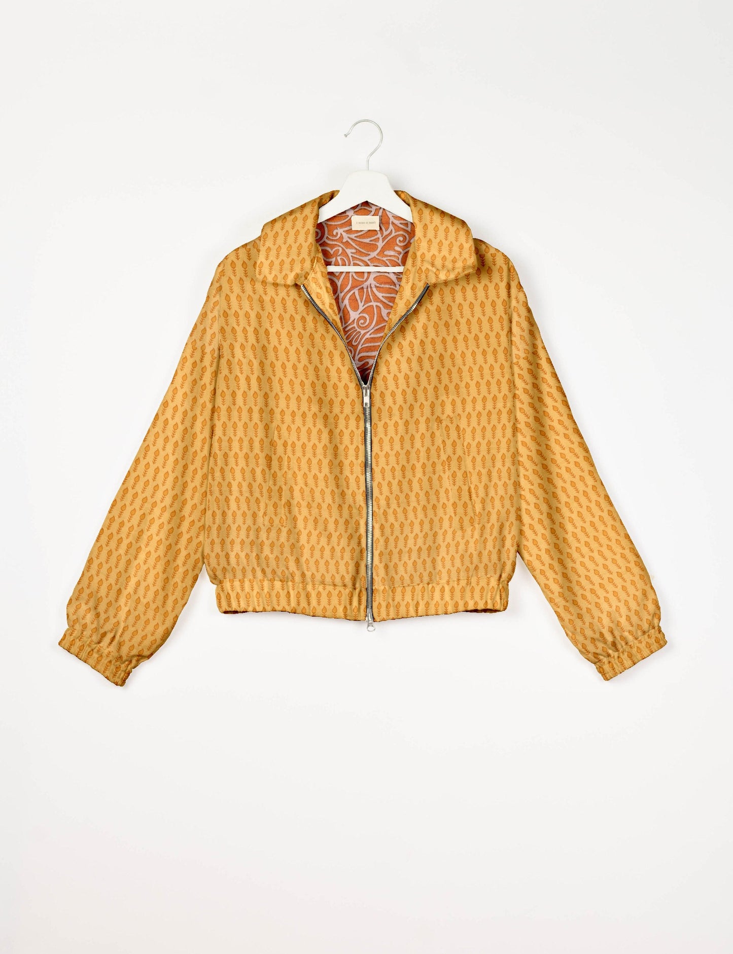 Upcycled Bomber Jacket made from recycled sari materials, featuring a cute cropped shape, elasticated hem and cuffs, and contrast sari print lining. Sustainable apparel promoting eco-friendly fashion and ethical clothing.