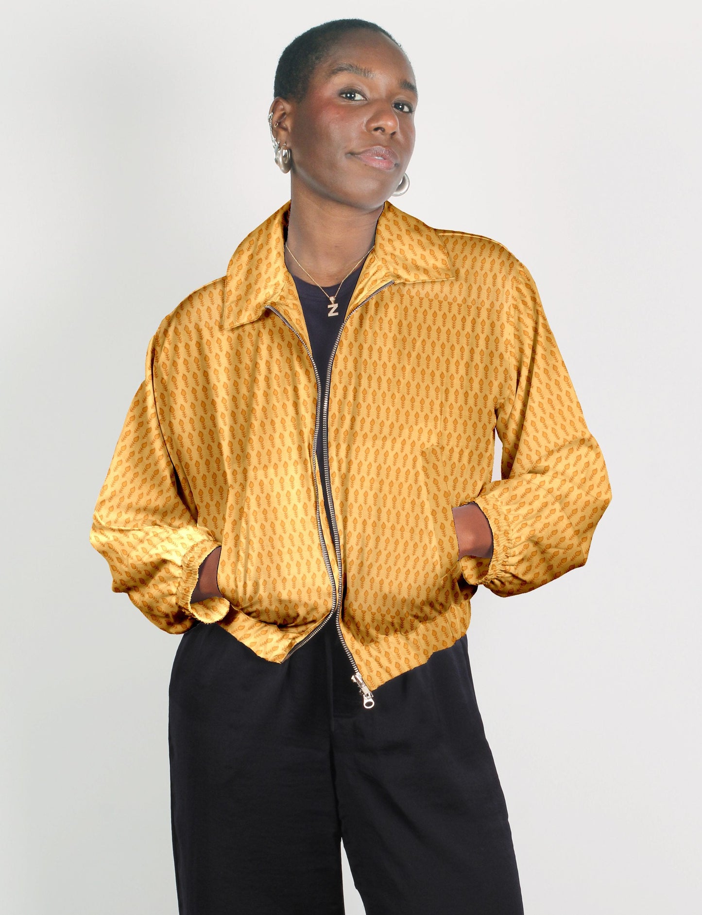 Upcycled Bomber Jacket made from recycled sari materials, featuring a cute cropped shape, elasticated hem and cuffs, and contrast sari print lining. Sustainable apparel promoting eco-friendly fashion and ethical clothing.