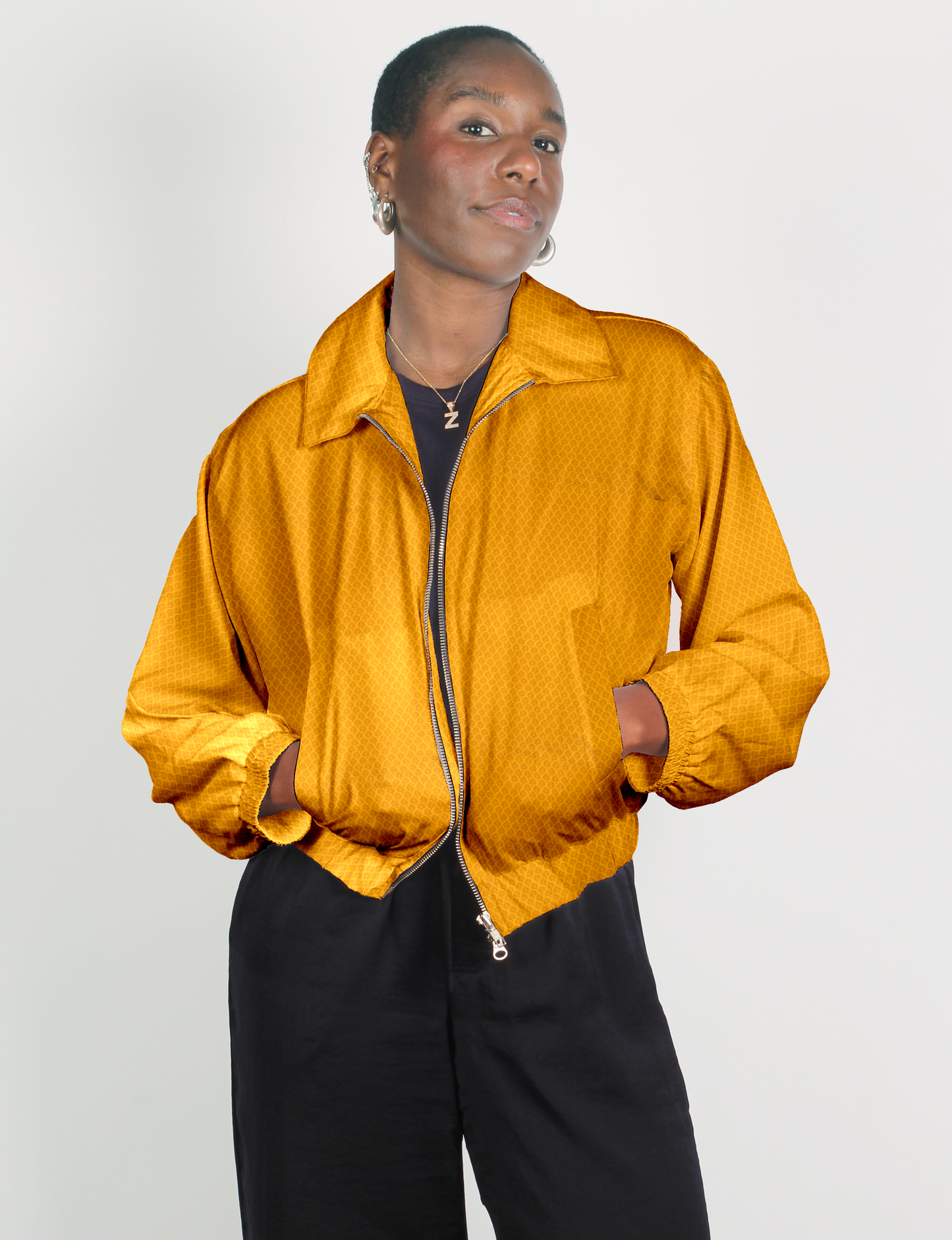 Upcycled Bomber Jacket made from recycled sari materials, featuring a cute cropped shape, elasticated hem and cuffs, and contrast sari print lining. Sustainable apparel promoting eco-friendly fashion and ethical clothing.