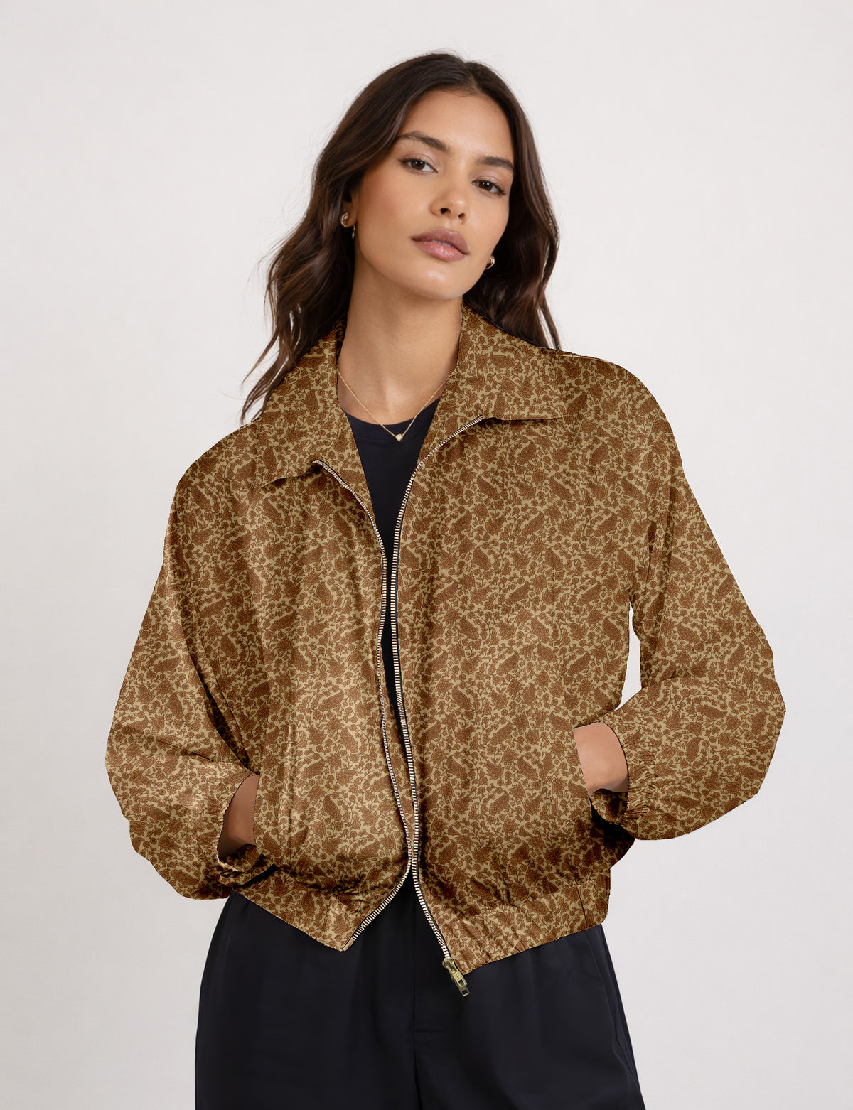 Woman wearing a yellow floral bomber jacket with front zipper, elastic cuffs, and side pockets, shown from front view