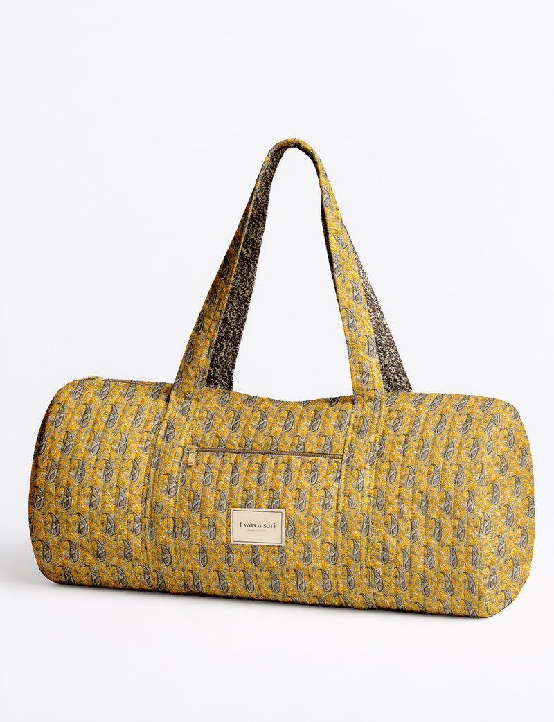 Quilted brown paisley bowling bag with gold zipper, floral interior lining, and interior key clip with label inside pocket