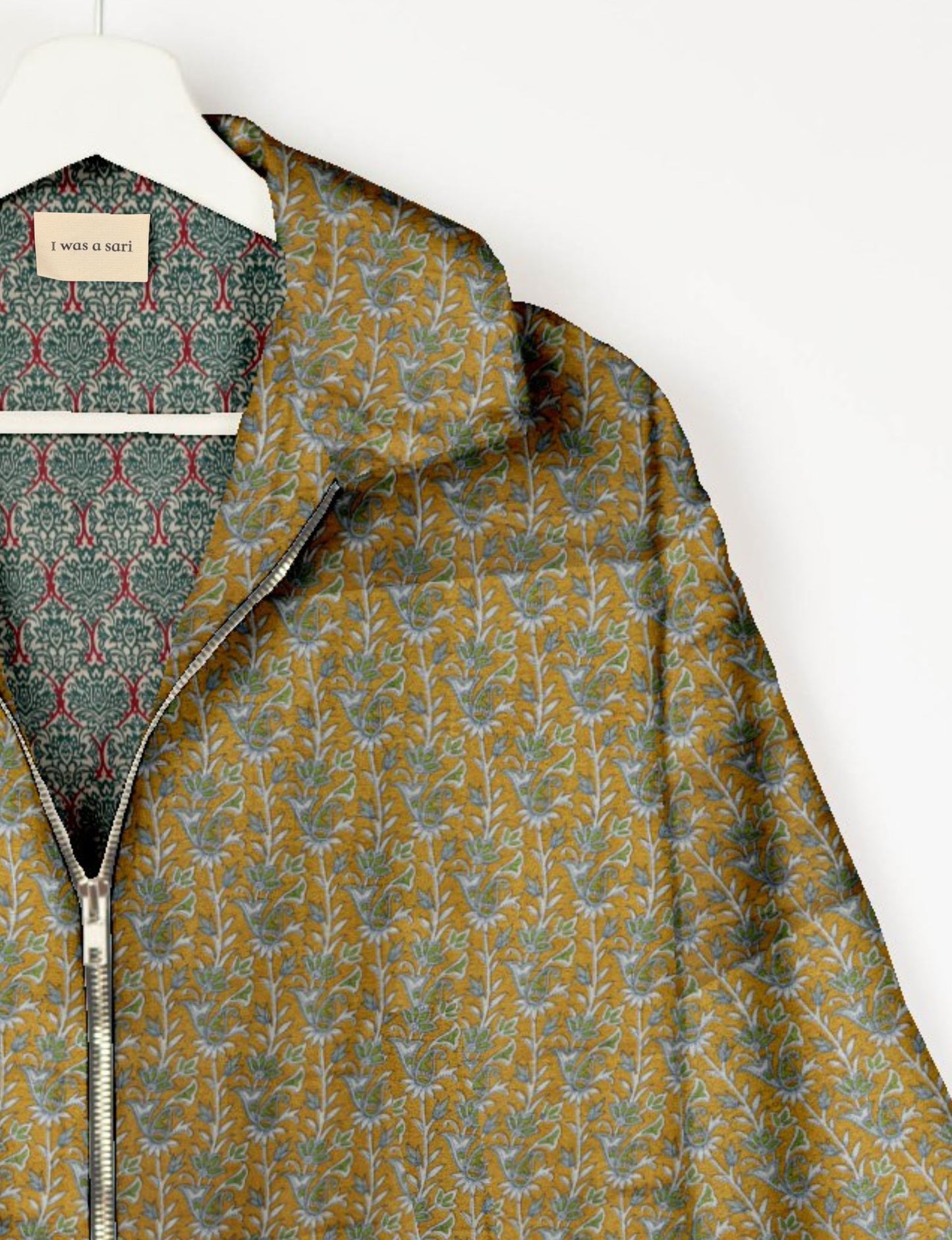 Upcycled Bomber Jacket made from recycled sari materials, featuring a cute cropped shape, elasticated hem and cuffs, and contrast sari print lining. Sustainable apparel promoting eco-friendly fashion and ethical clothing.