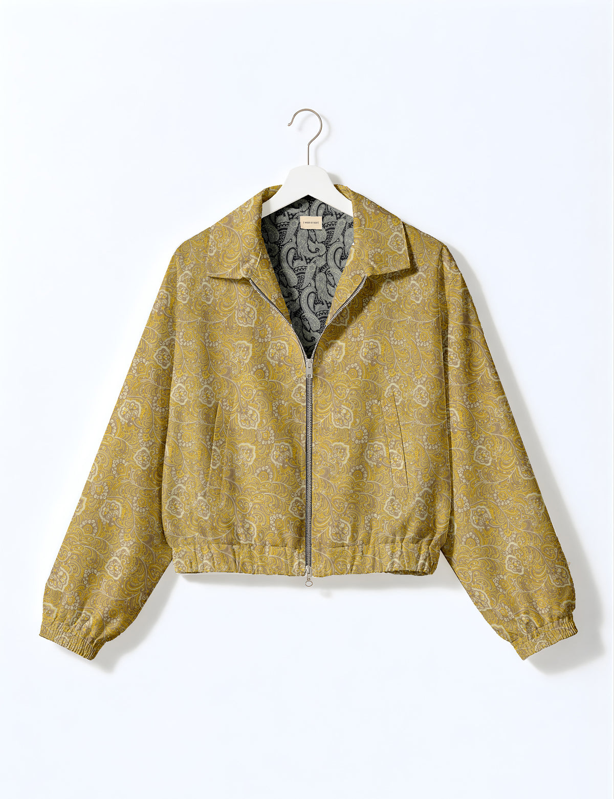 Brown floral bomber jacket with front zipper, elastic cuffs and hem, hanging on white hanger, red floral inner lining visible