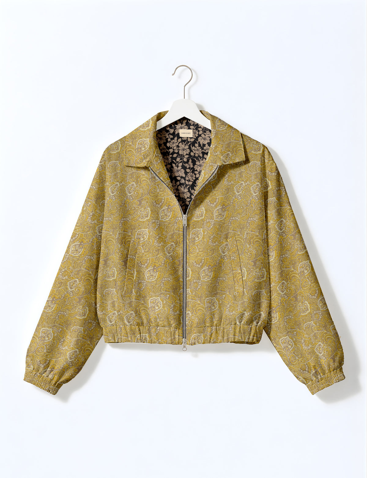 Woman wearing a yellow floral bomber jacket with front zipper, elastic cuffs, and side pockets, shown from front view